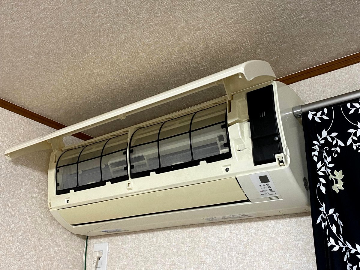 室内でエアコン本体を分解して作業する様子